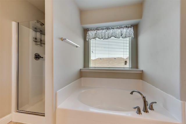 bathroom featuring shower with separate bathtub