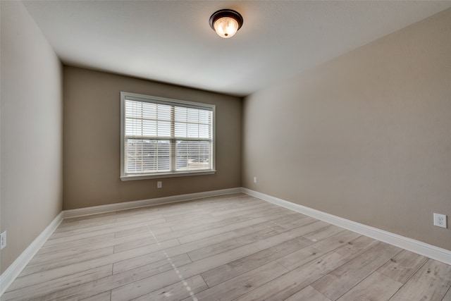 spare room with light hardwood / wood-style flooring