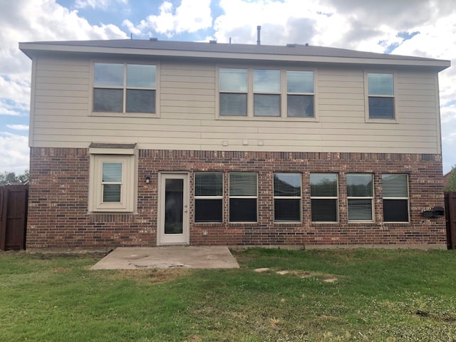 back of property featuring a patio and a lawn