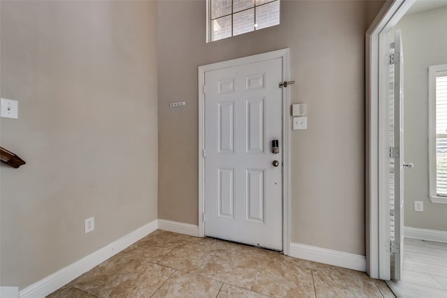 tiled foyer featuring plenty of natural light