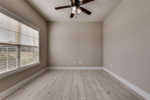 spare room featuring light wood-type flooring and ceiling fan