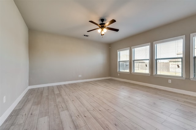 empty room with light hardwood / wood-style flooring and ceiling fan