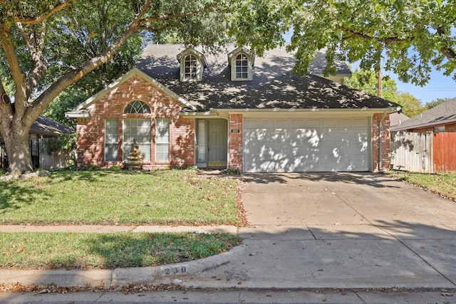 view of front of home with a garage and a front lawn