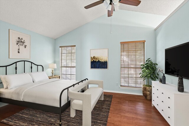 bedroom with dark hardwood / wood-style flooring, vaulted ceiling, multiple windows, and ceiling fan