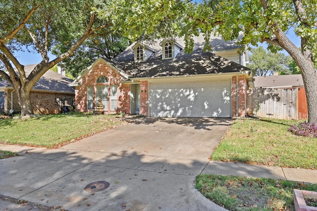 view of front of home with a front lawn and a garage