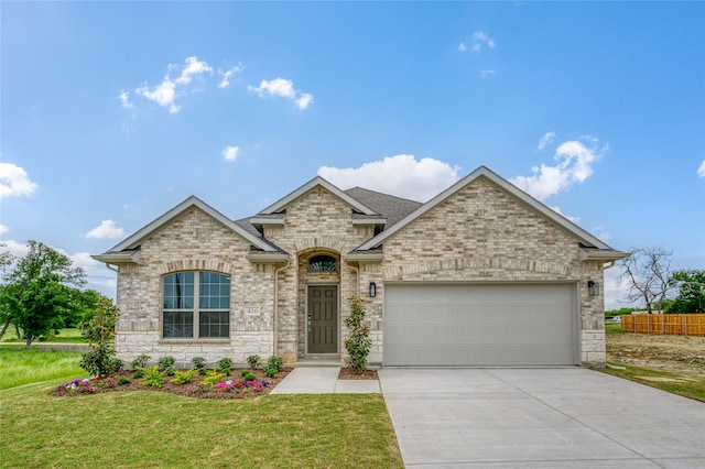 view of front of house featuring a front yard and a garage