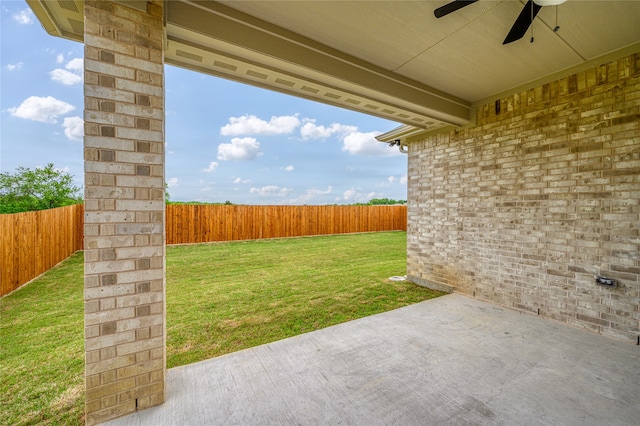 view of yard with ceiling fan and a patio