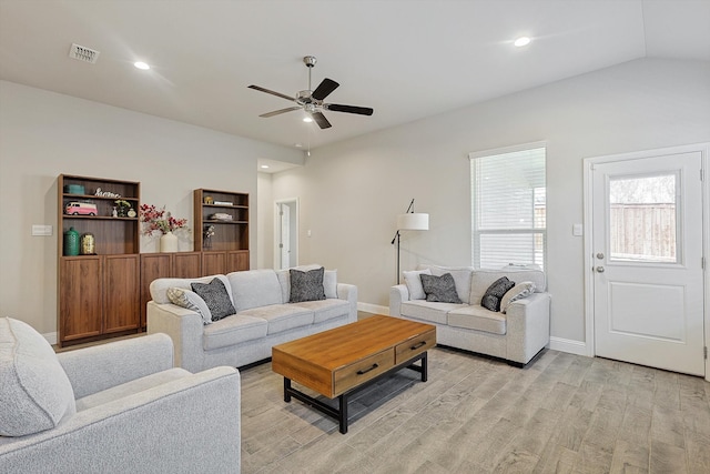 living room with ceiling fan, light hardwood / wood-style floors, and lofted ceiling