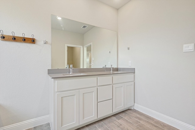 bathroom with wood-type flooring and vanity