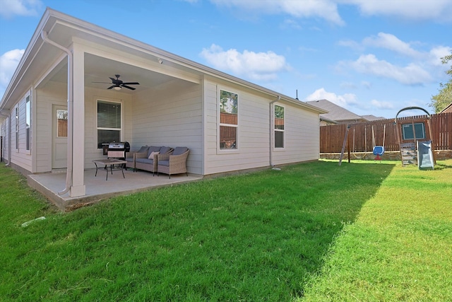 back of property featuring ceiling fan, a patio area, and a yard