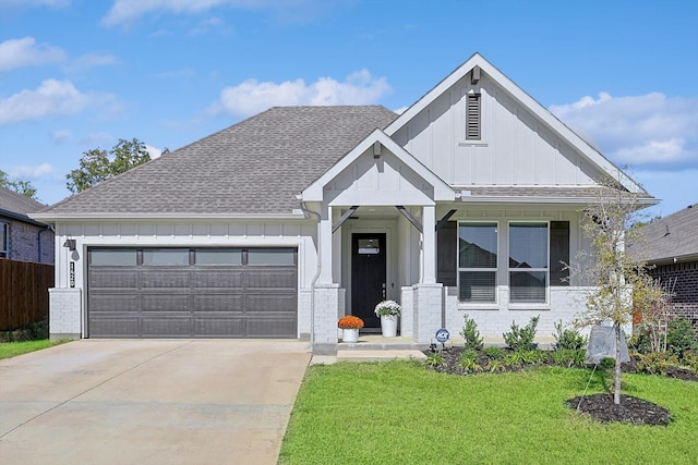 view of front of home featuring a front lawn and a garage