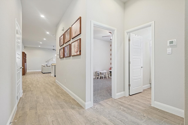 hallway with light hardwood / wood-style flooring