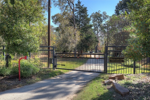 view of gate featuring a lawn