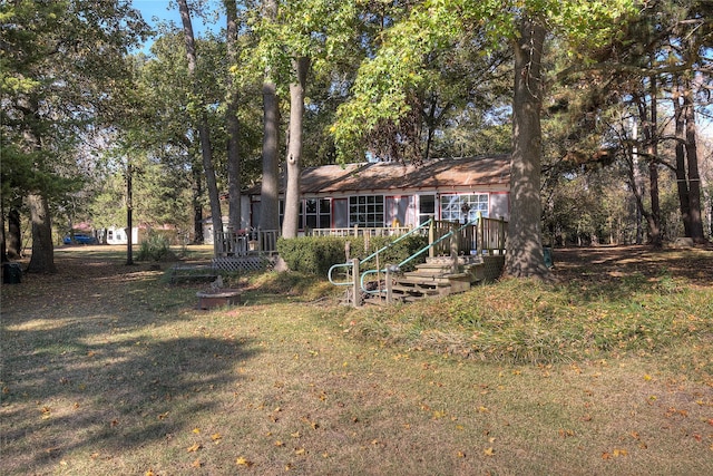 back of house with a lawn