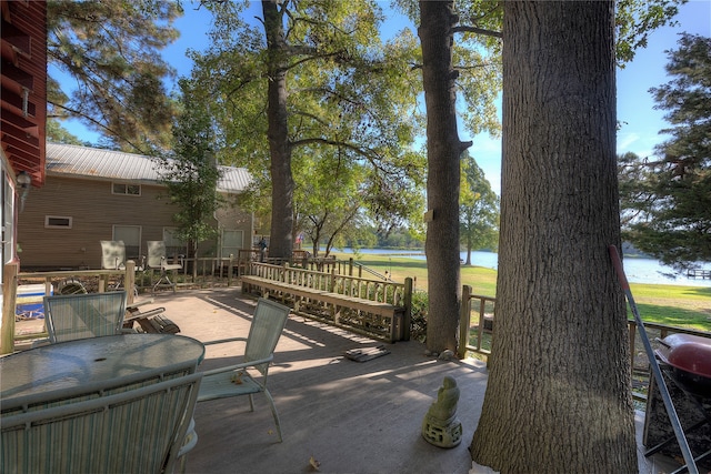 view of patio featuring a deck with water view