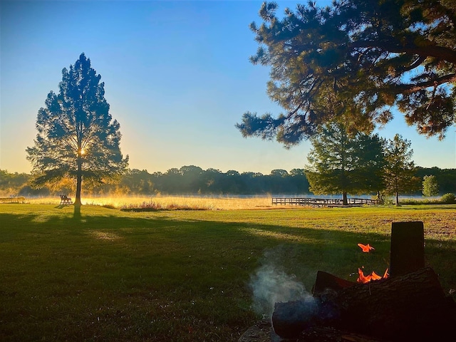 yard at dusk featuring a rural view