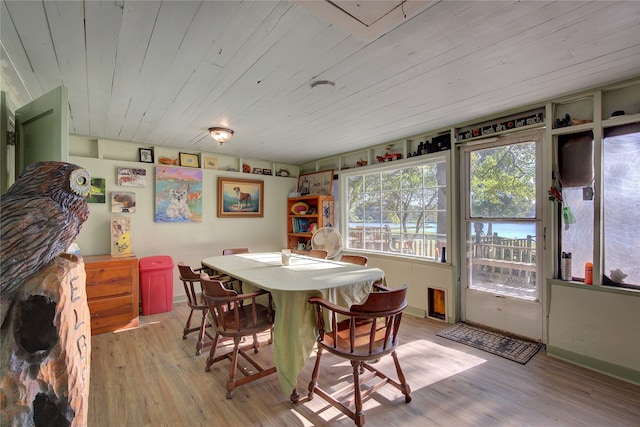 dining area featuring light wood-type flooring and wood ceiling