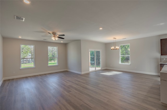 unfurnished living room with ceiling fan with notable chandelier and light hardwood / wood-style flooring