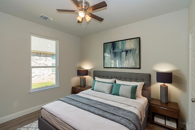 bedroom featuring ceiling fan and dark hardwood / wood-style floors