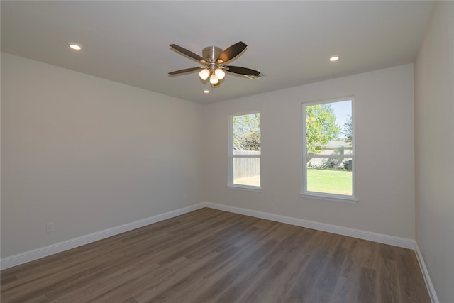 unfurnished room featuring dark wood-type flooring and ceiling fan