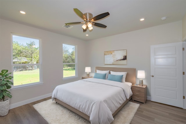 bedroom with hardwood / wood-style floors and ceiling fan