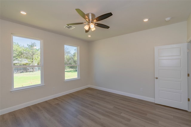 spare room with wood-type flooring and ceiling fan