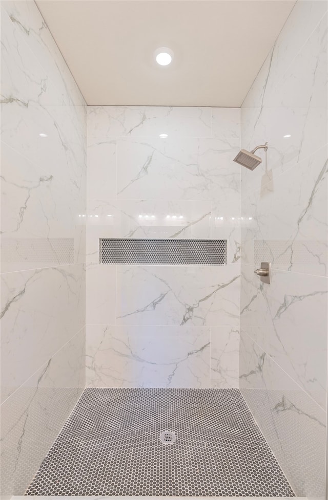 bathroom with tiled shower