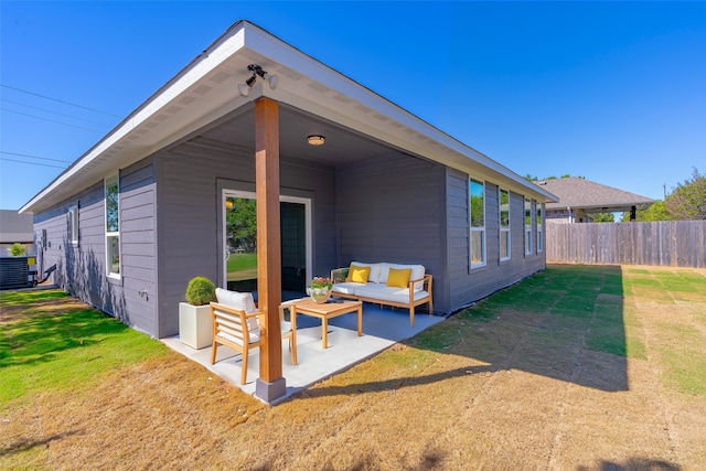 back of property featuring central AC unit, outdoor lounge area, and a lawn