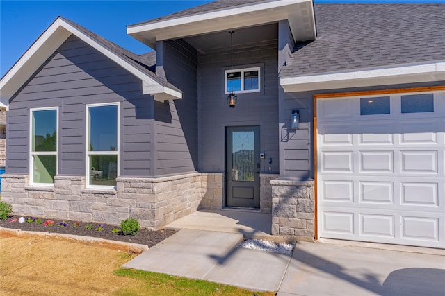 view of exterior entry with a garage