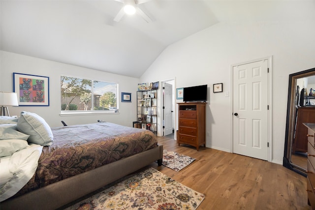 bedroom with ceiling fan, light hardwood / wood-style floors, and vaulted ceiling