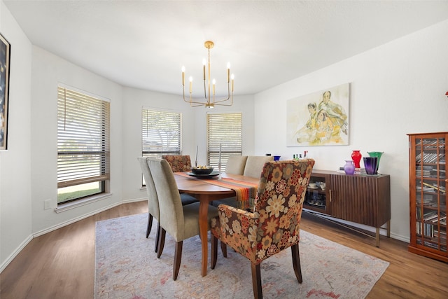 dining space featuring hardwood / wood-style floors and a notable chandelier