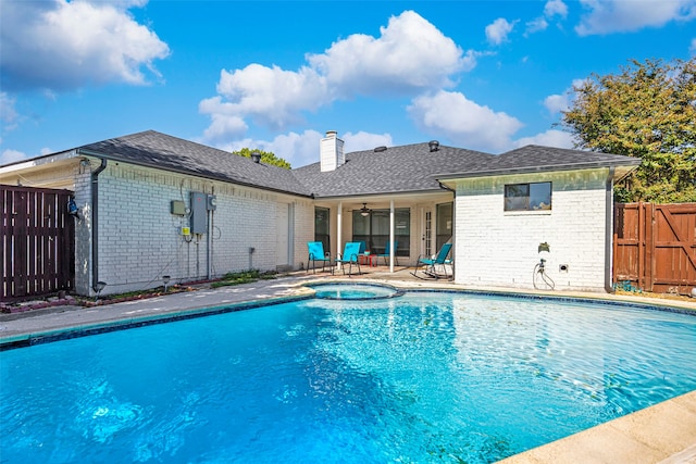 view of pool with ceiling fan, a patio area, and an in ground hot tub