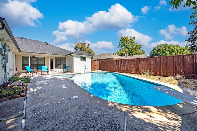 view of swimming pool with ceiling fan and a patio area