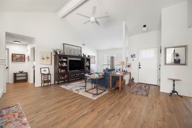 living room featuring beamed ceiling, high vaulted ceiling, and hardwood / wood-style flooring