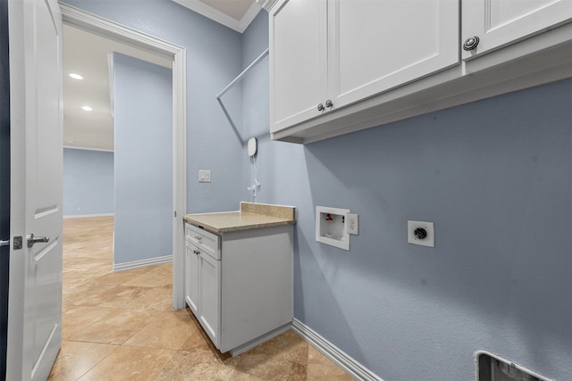 clothes washing area featuring cabinets, washer hookup, ornamental molding, and electric dryer hookup