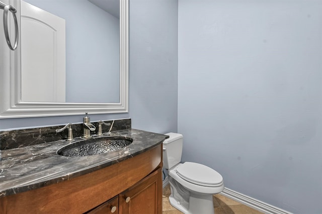 bathroom with tile patterned flooring, vanity, and toilet