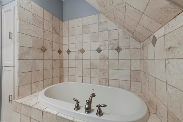 bathroom featuring tiled tub