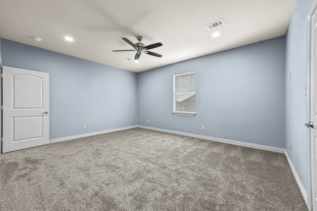 unfurnished room featuring ceiling fan and carpet