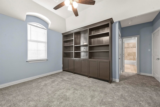 interior space featuring carpet flooring and ceiling fan