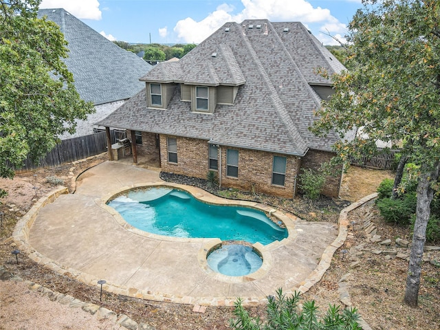 view of swimming pool featuring an in ground hot tub and a patio