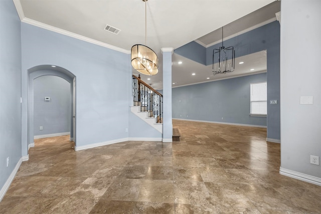 empty room featuring a chandelier and crown molding