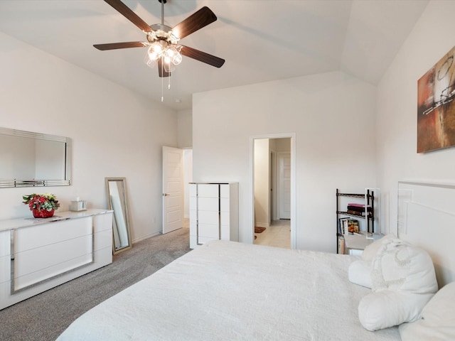 carpeted bedroom featuring ceiling fan and vaulted ceiling