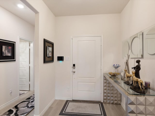 foyer entrance with light wood-type flooring