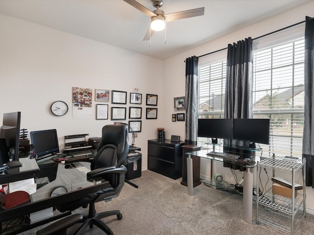 carpeted office space featuring ceiling fan and a healthy amount of sunlight