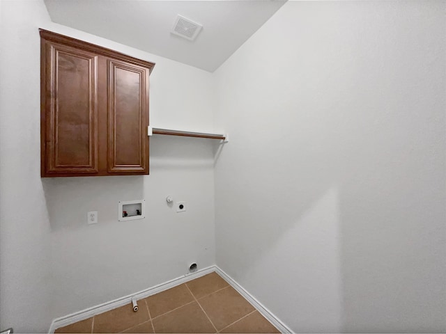 clothes washing area featuring cabinets, washer hookup, gas dryer hookup, electric dryer hookup, and tile patterned flooring