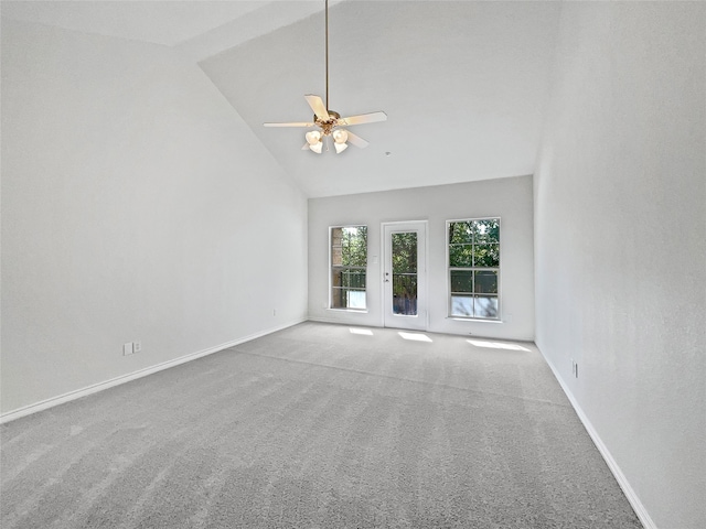 carpeted empty room featuring high vaulted ceiling and ceiling fan