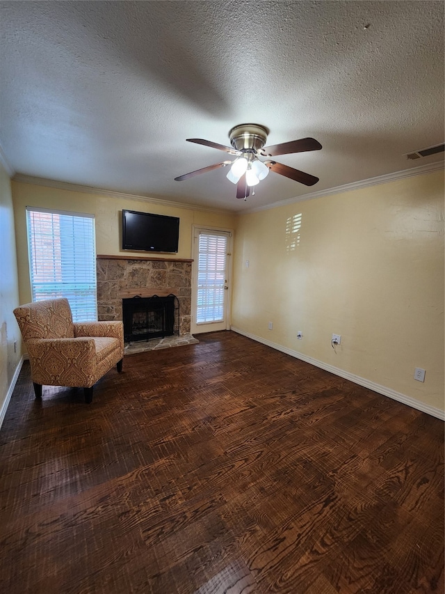 unfurnished living room with a wealth of natural light, a fireplace, and a textured ceiling