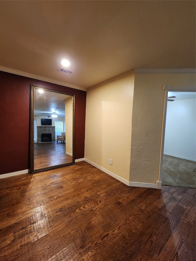 spare room with wood-type flooring and crown molding