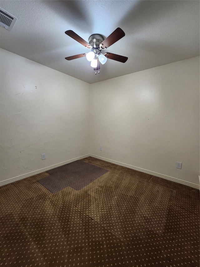 carpeted empty room featuring a textured ceiling and ceiling fan