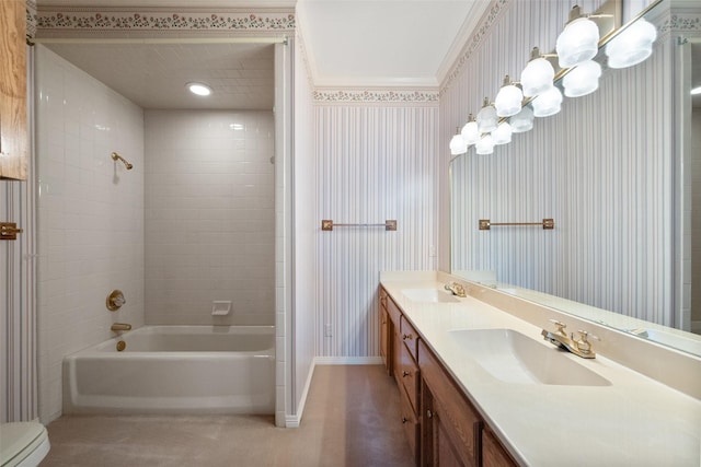 full bathroom featuring toilet, vanity, and tiled shower / bath combo